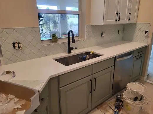 Arabesque backsplash around a window above the sink