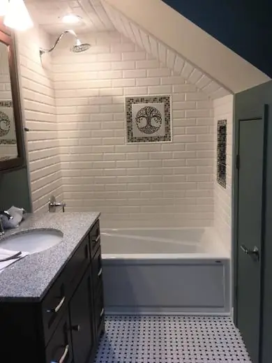 Beveled subway tub surround with a tile inlay medallion