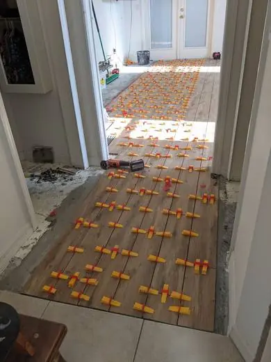 Wood-look planks with leveling clips before grout