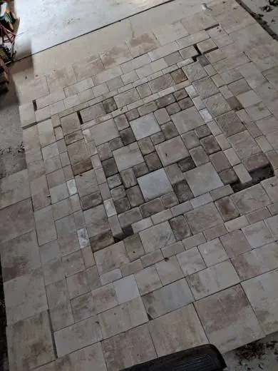 Travertine French-pattern floor during installation