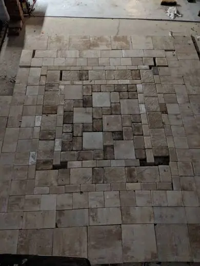 Travertine floor laid in a French pattern with a center feature