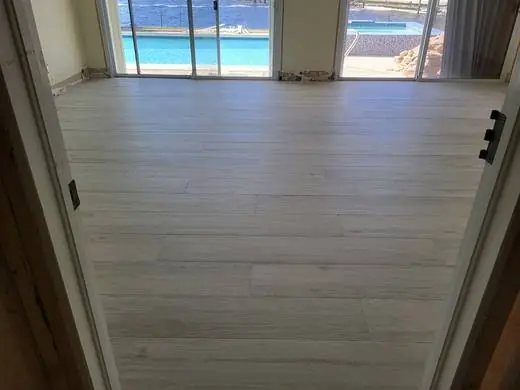 Wood-look porcelain plank floor with pool views