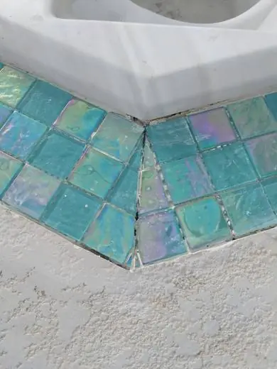 Iridescent teal glass pool tile detail