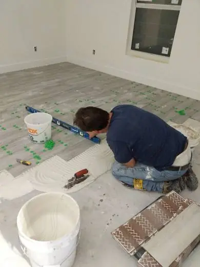 Shaun leveling large-format tile in fresh thinset
