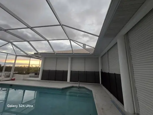Hurricane shutters installed along a pool lanai